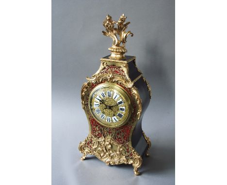 A RED BOULLE AND ORMOLU MOUNTED MANTEL CLOCK dial white enamel numerals, movement striking on a gong, case with ebonised side