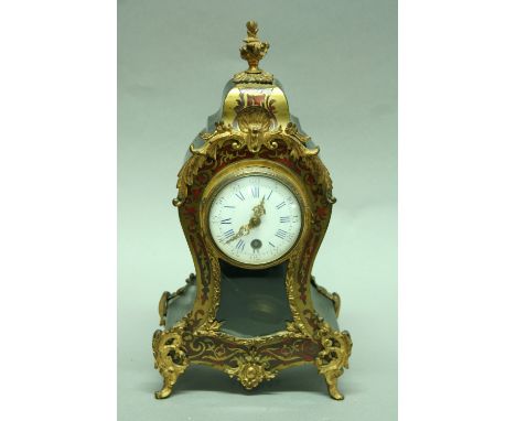 A FRENCH MANTEL CLOCK with shaped red boulle case and enamel dial height 13.5" (34 cms)