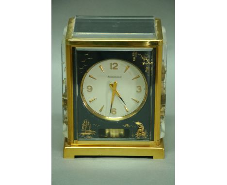 A JAEGER LE COULTRE MANTEL CLOCK the front and sides set with black and gold lacquered chinoiserie panels, brass and glazed c