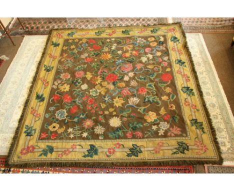 A NEEDLEWORK CARPET of early 18th century design, worked with a bold floral design on a brown field, yellow border approx 9' 