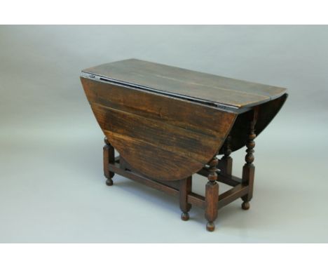 A 17TH CENTURY OAK GATE LEG TABLE the oval top on a ball and blade turned underframe top 47.75" (121.5 cms) x 57" (144.5 cms)