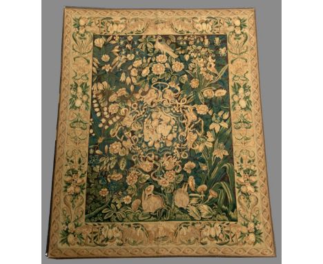 A TAPESTRY PANEL in tones of green and ochre, the field inhabited with rabbits, a bird, fruit and flowers 9' 9" (297 cms) x 7