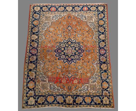 A TABRIZ CARPET in tones of orangey red, cream and blue, the dark blue border with palmettes (pile low/condition fair) 12' 3"