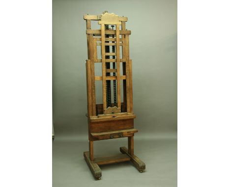 AN OAK DOUBLE EASEL with wooden screw adjustment width 29" (74 cms), height approx 95" (240 cms)