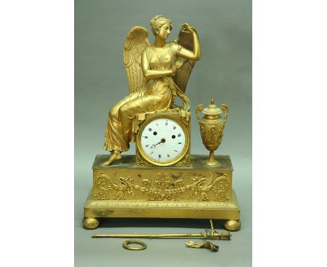 AN EMPIRE ORMOLU MANTEL CLOCK striking movement with enamel dial, signed Augustin a Paris, the case surmounted by a winged fe