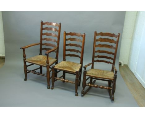 A SET OF 8 BEECH RUSH SEATED LADDER BACK CHAIRS INCLUDING TWO WITH ARMS together with a pair of rocker arm chairs