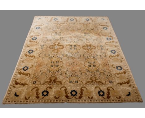 AN AGRA TYPE WOOL CARPET in blue and beige with bold floral border 12' 5" (378 cms) x 9' 7" (302 cms)