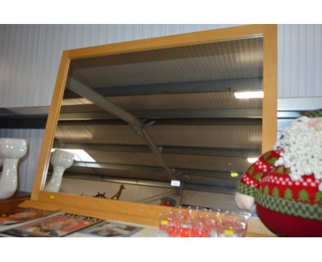 A light oak framed mirror
