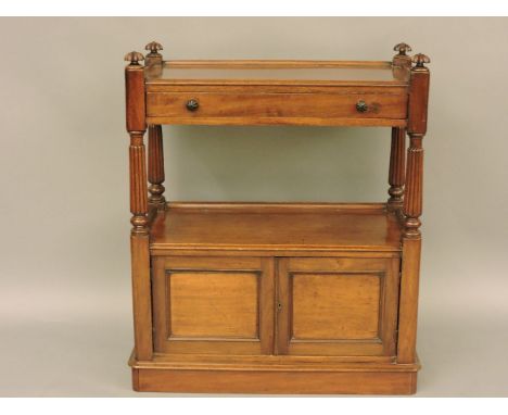 A Victorian mahogany buffet, with turned and fluted finials, the top section with a drawer, the base with cupboards on a plin