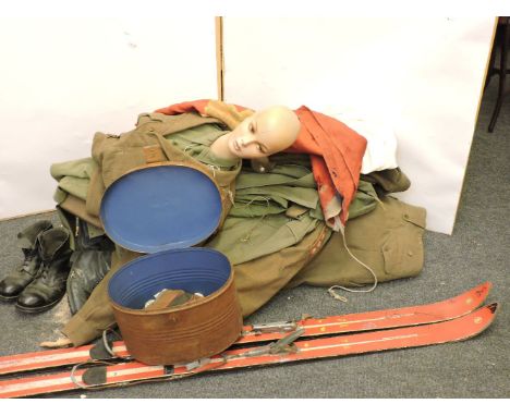 An army battle dress mannequin, wooden skis, smock, army boots, etc