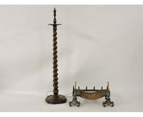 A cast iron fire grate, on a pair of dogs, 76cm wide, and a standard lamp