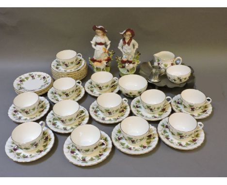 A Royal Worcester Bacchanal part teaset, a pair of figures, and pewter