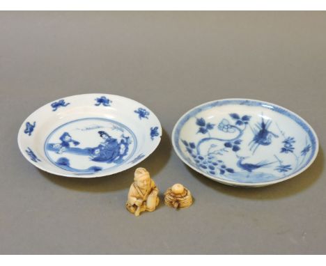 A Kangxi Chinese blue and white porcelain saucer, decorated with figures in a garden and with four character mark to the base