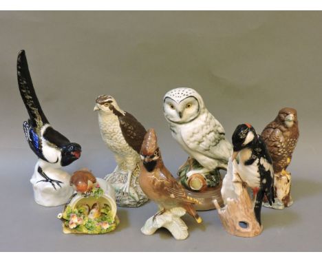 A Beswick Beneagles Whisky Osprey and Buzzard, a Goebel Woodpecker, Royal Doulton Robin and its young, and further bird figur