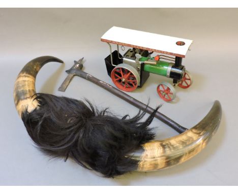 A Mamod steam tractor, a tribal axe, and a set of bull horns