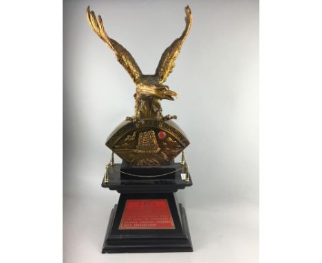 20TH CENTURY CHINESE GILT MODEL OF AN EAGLE, modelled upon a gilt seascape scene, on a tapered, stepped base with red present