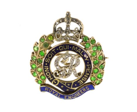 A DEMANTOID GARNET AND ENAMEL ROYAL ENGINEERS CAP BADGE / BROOCH, CIRCA 1920 designed as the Order of the Garter motto 'Honi 