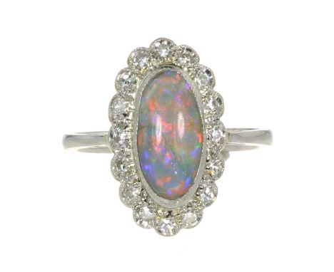 AN OPAL AND DIAMOND CLUSTER RING set with a central cabochon opal of 1.75 carats encircled by a border of round cut diamonds.