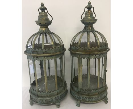 A Pair of modern Eastern style metal and glass panel lanterns with hinged doors. Freestanding and with hooks for hanging. App