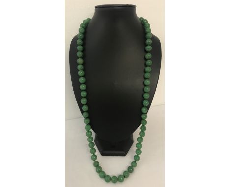 A 32" jade beaded necklace, knotted between each bead.  Beads approx. 1.25cm diameter.