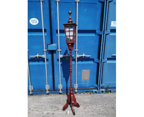 An Arts &amp; Crafts style stained wood 'street lamp' standard lamp.