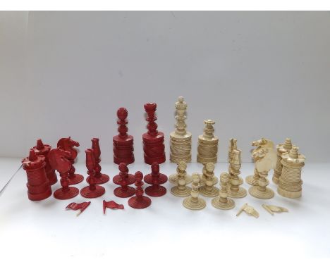 An incomplete  large 19thC Indian red &amp; white stained bone chess set, the kings 5" high - missing five red pawns, four wh