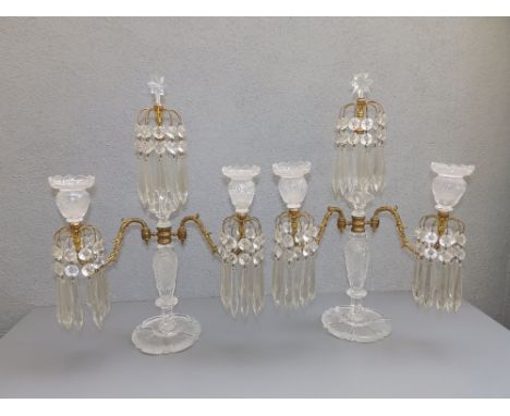 A pair of Regency cut glass &amp; ormolu lustre candelabra, the central column surmounted by a row of lustre drops beneath a 