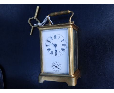 A French gilt brass alarum carriage clock, the white enamel dial with a crack and damage to upper corner, ringing on a bell b