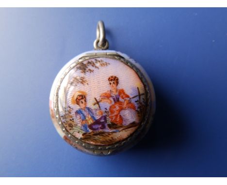A circular white metal silver pendant vinaigrette, painted overall in enamel to depict a young courting couple in a rustic sc
