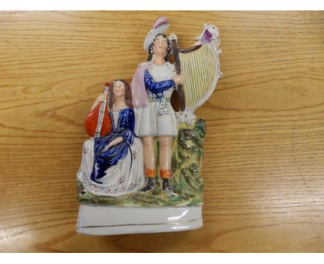 A Victorian Staffordshire pottery figure group - Musicians with harp, 12.5" high and an old blue &amp; white carpet bowl. (2)