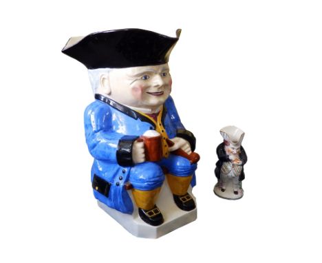 A giant Devonmoor Pottery toby jug, dressed in blue jacket, with black hat, yellow waistcoat &amp; stockings, clutching a foa