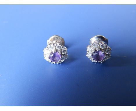 A pair of amethyst &amp; diamond cluster earrings in '18k' white metal.