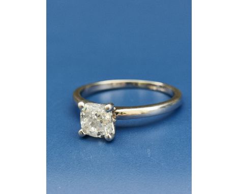 A modern diamond solitaire, the cushion cut sone weighing 1.02 carats, held in four claws above 14k white metal shank, accomp
