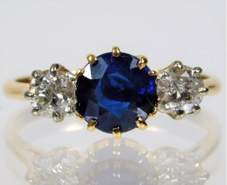 A yellow metal ring, tests as 18ct gold, set with sapphire &amp; approx. 0.5ct diamond 2.2g size K/L