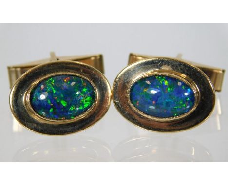 A pair of gents 9ct gold cufflinks set with black opal doublets 11.4g