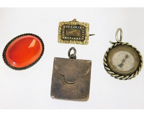 A 19thC. yellow metal &amp; pearl mourning brooch, a white metal carnelian brooch, a hallmarked silver stamp envelope &amp; a