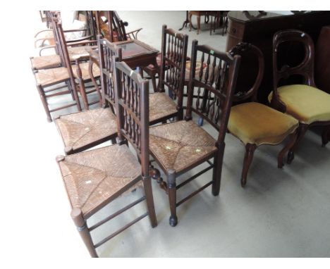 A set of four early 19th century chairs having Lancashire spindle backs, with later rush seats and bobbin and turned frames