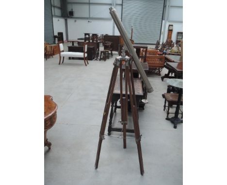 A late 20th Century reproduction (non-usable)  telescope having metal tube on treen tripod base