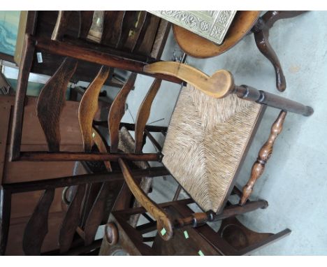 A composite set of four (2+2) early 19th century elm kitchen chairs, having wave ladder backs, with later rush seats and turn