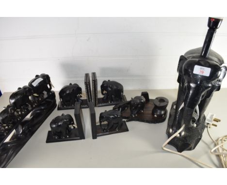 COLLECTION OF HARDWOOD EBONY ELEPHANTS COMPRISING TWO PAIRS OF BOOKENDS, FAMILY OF FIVE ELEPHANTS WALKING ON A BRIDGE, A DESK