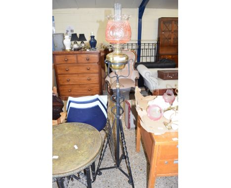 LATE 19TH/EARLY 20TH CENTURY OIL LAMP WITH COLOURED GLASS SHADE, BRASS FONT AND RAISED ON AN ADJUSTABLE IRON BASE, 158CM HIGH