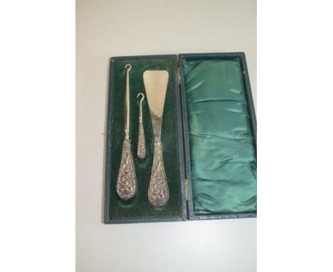 CASED SET OF SHOE HORN AND TWO BUTTON HOOKS WITH SILVER HANDLES