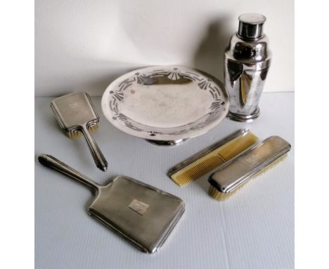 An Art Deco German 835 silver four-piece brush set with engine turned design, initialled; a silver plated cocktail shaker, 20