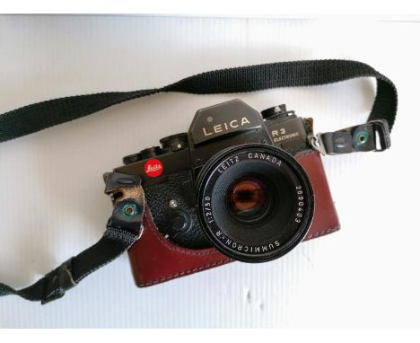 A Leica Electronic R3 camera and case with conforming Summicron-R 1:2/50 lens 