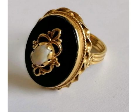 A Victorian oval gold and enamel mourning ring with opal, size L, stamped 14K, 7.25g 