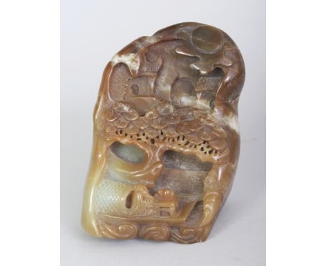 A CHINESE BROWN JADE BOULDER, carved in deep relief with a river boat beneath pine and beneath a moon shrouded settlement, 3.