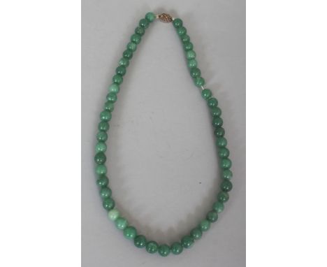 A CHINESE JADE-LIKE GREEN HARDSTONE NECKLACE, composed of spherical beads, approx. 20.25in long.