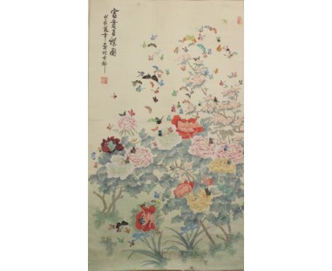 A 20TH CENTURY CHINESE HANGING SCROLL PAINTING ON SILK, depicting butterflies hovering above a profusion of flowers and leafa