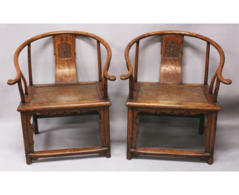 A GOOD PAIR OF CHINESE HARDWOOD & RATTAN HORSESHOE BACK ARMCHAIRS, of larger than average size, each arm with carved scroll e