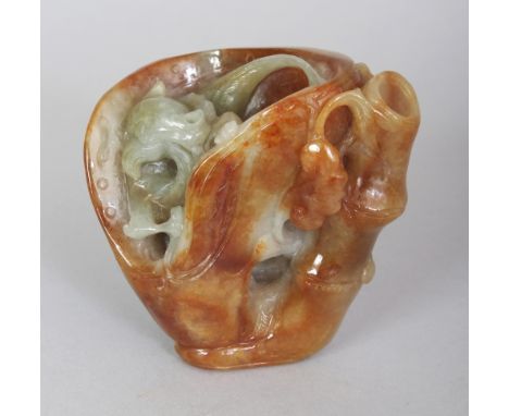 A SMALL CHINESE JADE BRUSHWASHER, in the form of a chilong nestled in an open pod beside bamboo and lingzhi, 2.5in wide at wi